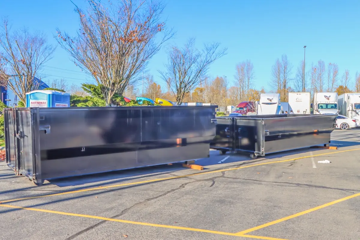 Professional dumpster rental service with roll-off container on residential driveway in Hamtramck